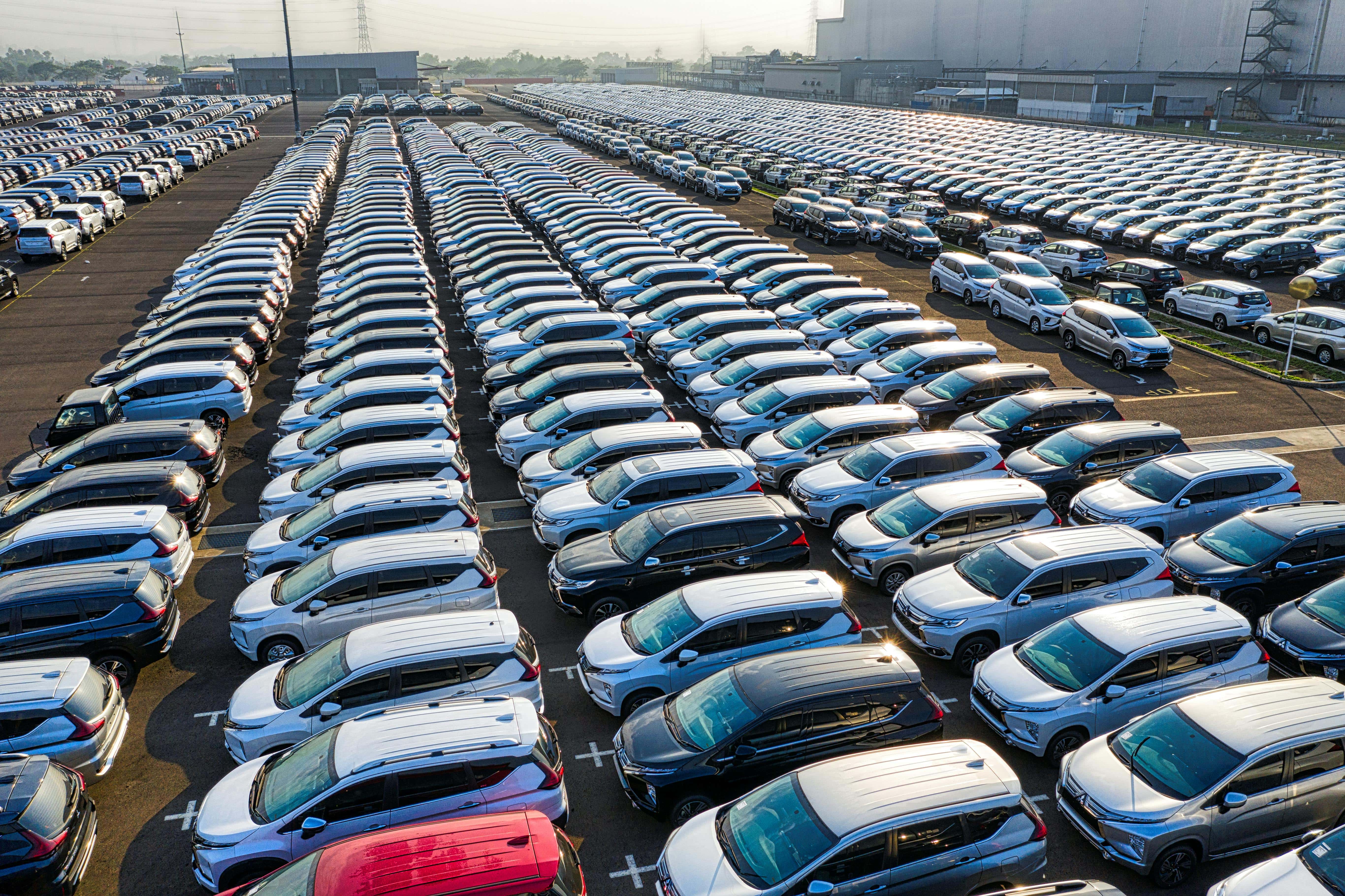 different cars parked in a big scrap yard