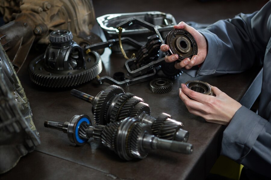 a mechanic holding various car spare parts