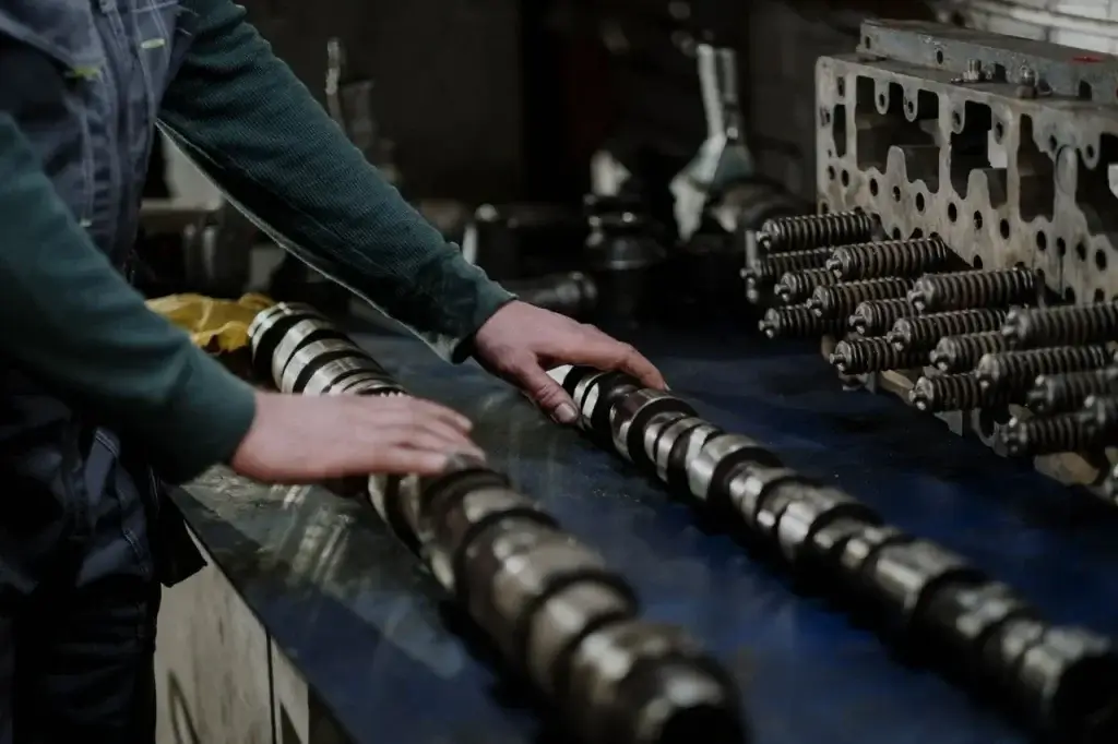 Car Parts Suppliers, A mechanic arranging car parts on top of a table